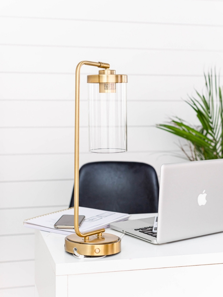 A laptop and desklamp sitting on a home office desk
